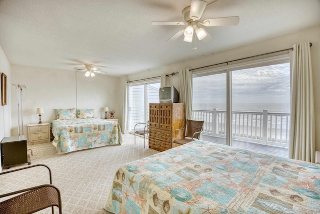 bedroom with light carpet, a textured ceiling, access to outside, and ceiling fan