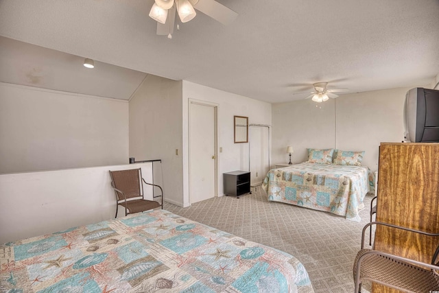 carpeted bedroom with a textured ceiling and ceiling fan