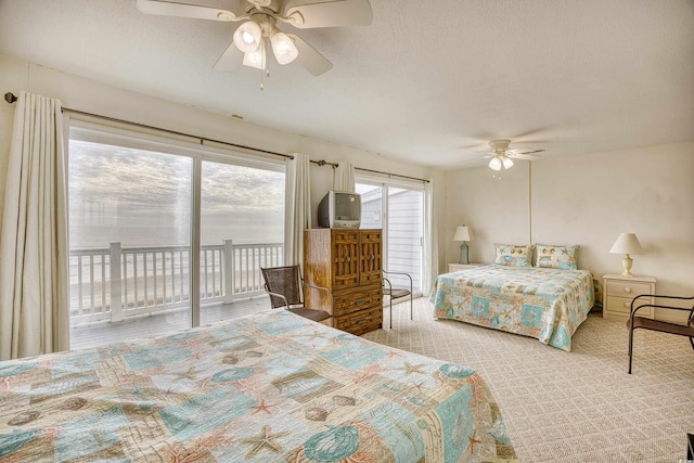 bedroom with light carpet, a textured ceiling, ceiling fan, and access to exterior