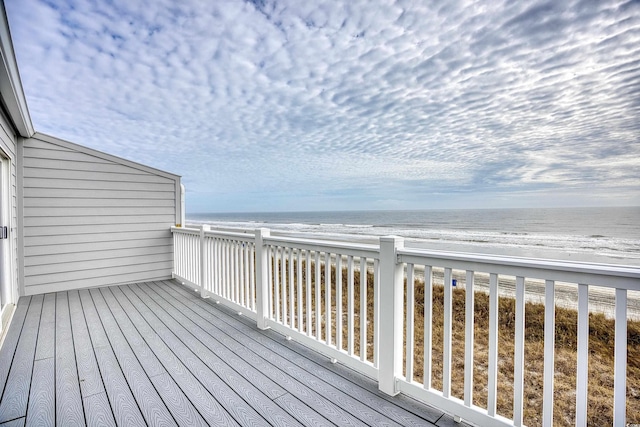 wooden terrace featuring a water view