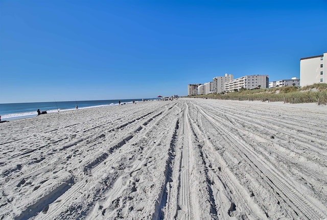 exterior space featuring a water view and a view of the beach