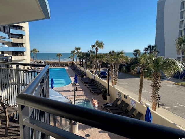 view of pool featuring a water view