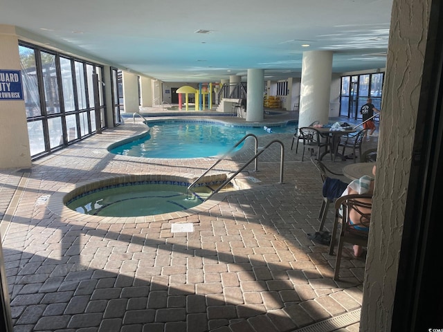 view of swimming pool featuring an indoor hot tub