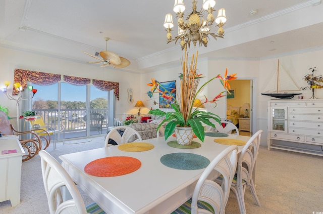 dining room featuring crown molding, ceiling fan with notable chandelier, and a raised ceiling