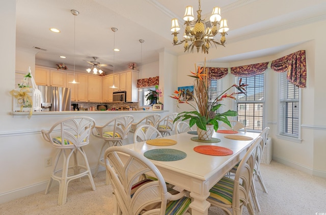 dining space with ornamental molding and ceiling fan with notable chandelier