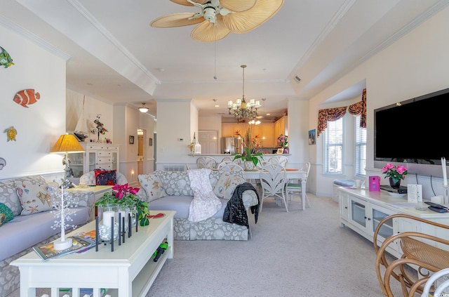 carpeted living room featuring ceiling fan with notable chandelier, ornamental molding, and a raised ceiling