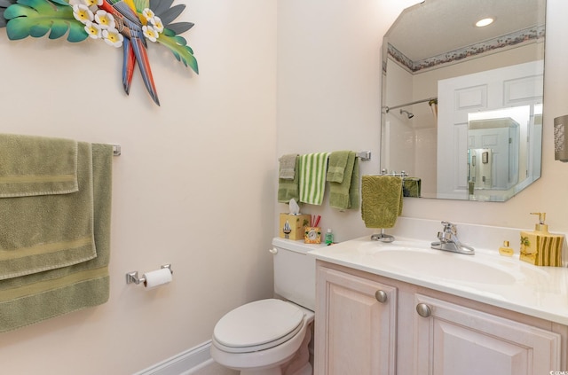 bathroom with toilet and vanity with extensive cabinet space