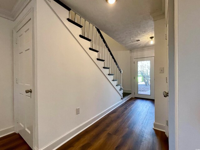 entryway featuring dark hardwood / wood-style flooring and a textured ceiling