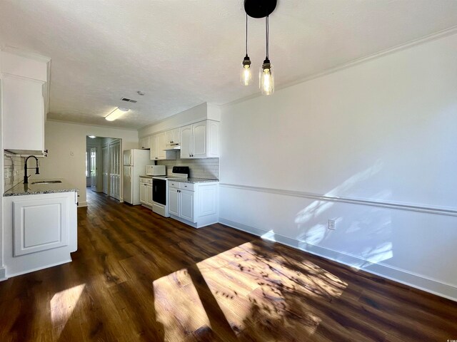 kitchen with tasteful backsplash, dark wood-type flooring, white appliances, white cabinetry, and sink