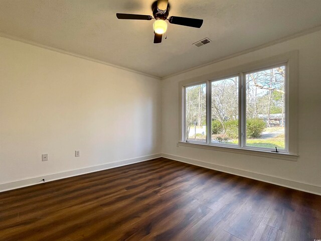 empty room with crown molding and dark hardwood / wood-style floors