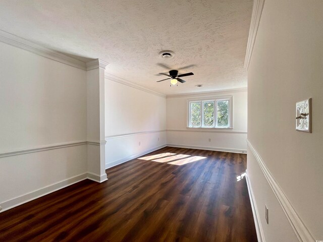 spare room featuring dark hardwood / wood-style flooring, ceiling fan, ornamental molding, and a textured ceiling