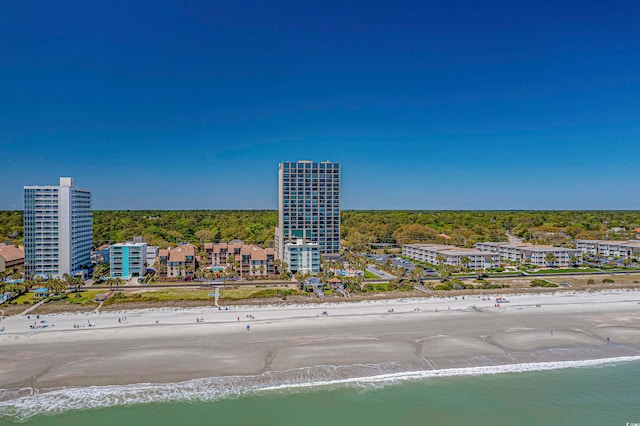 drone / aerial view featuring a beach view and a water view