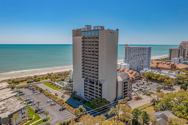 drone / aerial view with a beach view and a water view