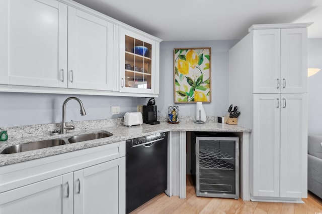 interior space featuring light hardwood / wood-style flooring, dishwasher, white cabinetry, and wine cooler