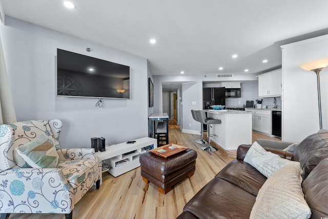 living room with light hardwood / wood-style floors