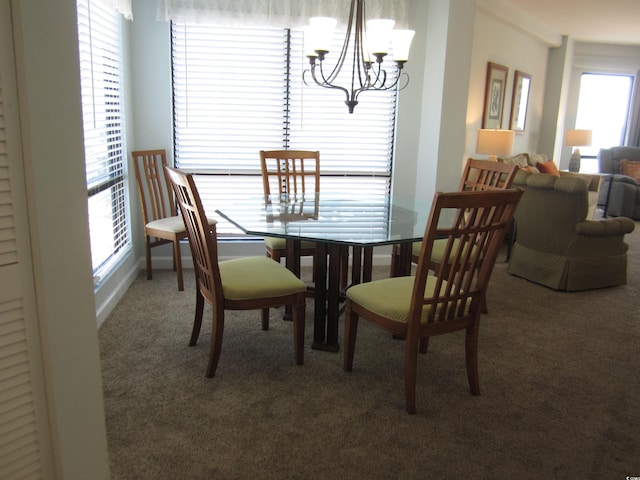 carpeted dining room featuring a notable chandelier and a wealth of natural light