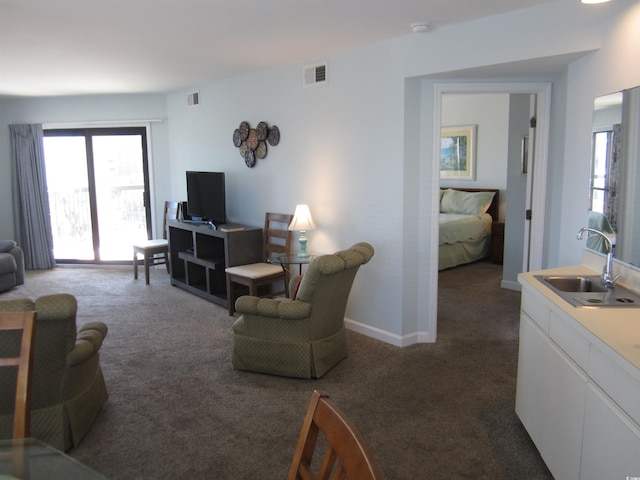 living room featuring carpet floors and sink