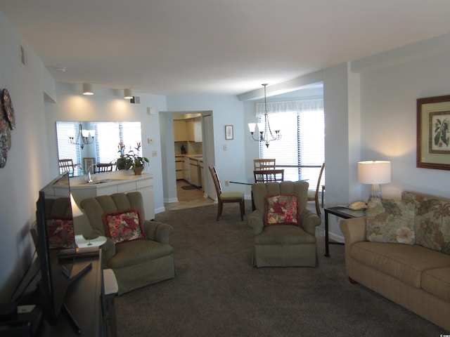 carpeted living room with a notable chandelier