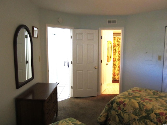 carpeted bedroom featuring ensuite bathroom