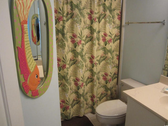 bathroom with vanity, toilet, and tile floors