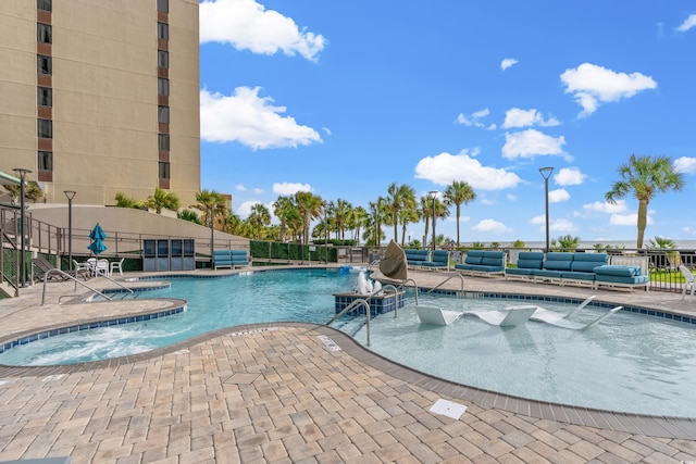 view of swimming pool featuring a patio and a jacuzzi