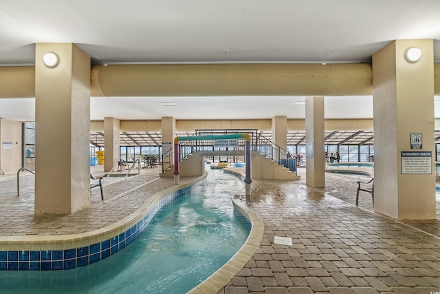 view of pool with an indoor hot tub