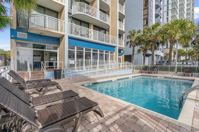 view of swimming pool with a patio