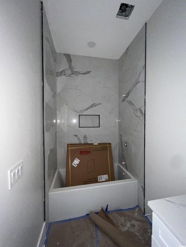 bathroom with a tile shower