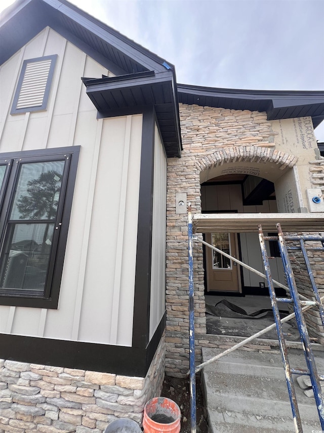 view of property exterior with stone siding and board and batten siding