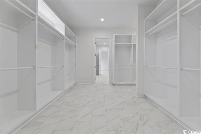 spacious closet with marble finish floor