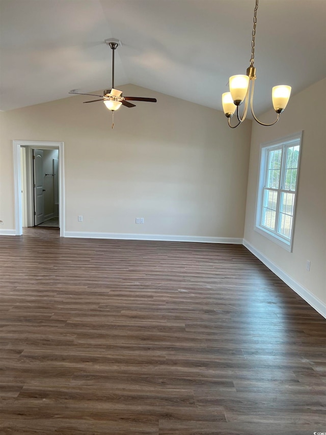 unfurnished room featuring ceiling fan with notable chandelier, vaulted ceiling, and dark hardwood / wood-style flooring