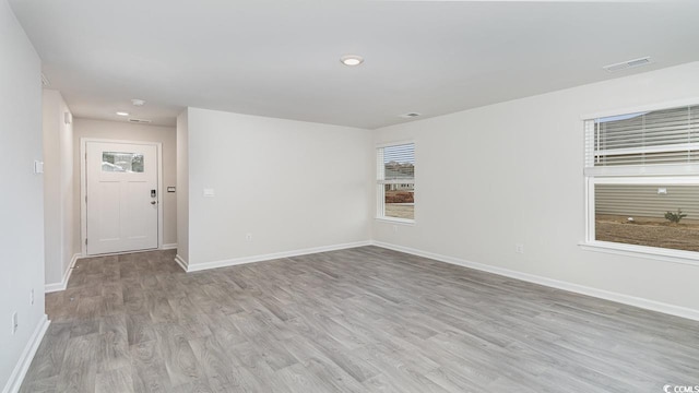 spare room with recessed lighting, visible vents, baseboards, and light wood-style floors