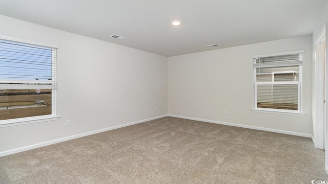 carpeted spare room with recessed lighting, visible vents, and baseboards