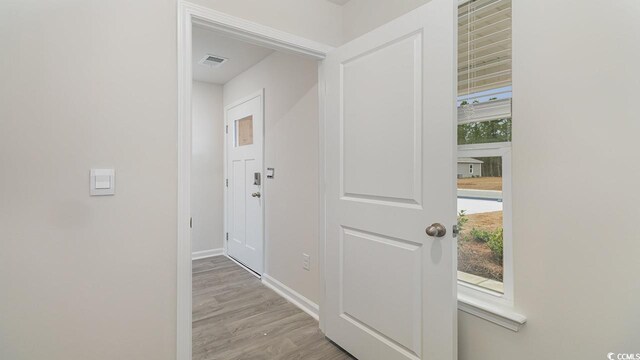 corridor featuring light hardwood / wood-style floors