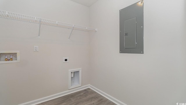 laundry room with baseboards, electric panel, laundry area, hookup for a washing machine, and electric dryer hookup