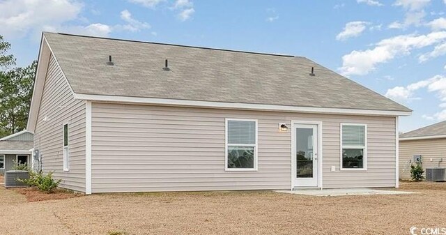 rear view of house with central AC unit