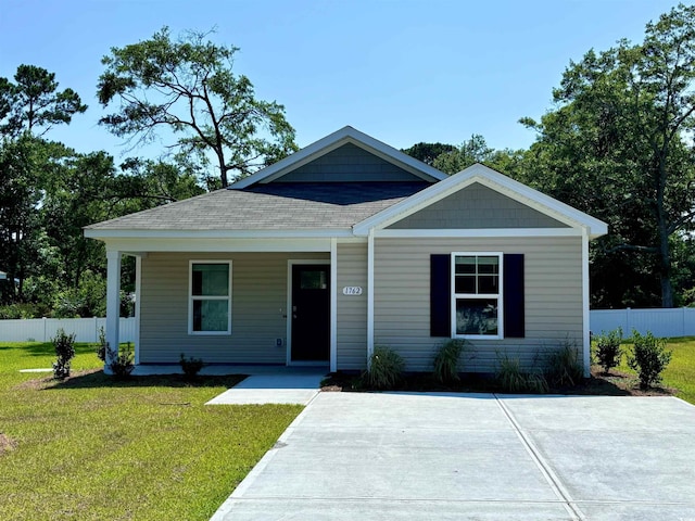 view of front of home featuring covered porch and a front yard