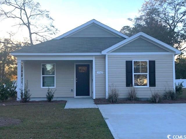 view of front of home featuring covered porch and a front yard