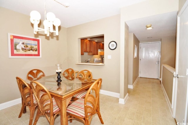 dining room with a notable chandelier and light tile flooring