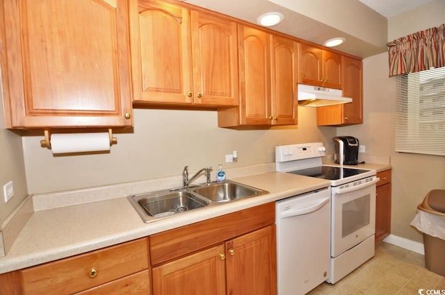 kitchen with white appliances, sink, and light tile flooring