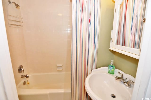 bathroom with sink and shower / tub combo with curtain