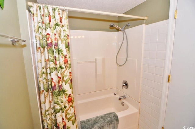 bathroom featuring shower / tub combo and a textured ceiling