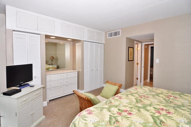 bedroom with light colored carpet and a closet