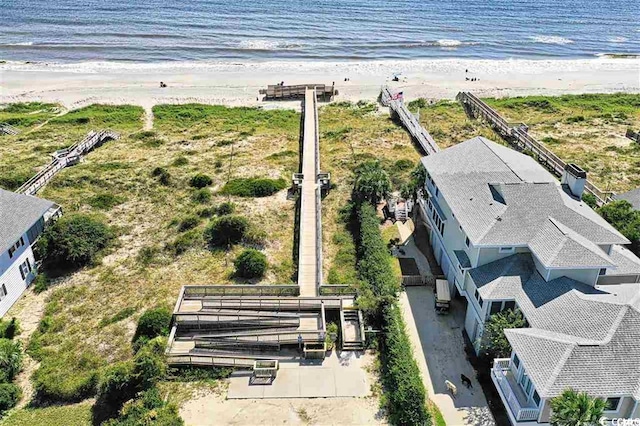 bird's eye view featuring a view of the beach and a water view