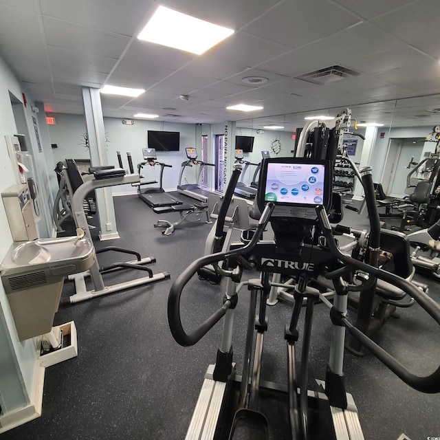 gym featuring a drop ceiling