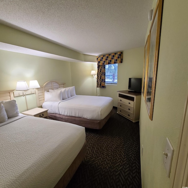 carpeted bedroom with a textured ceiling