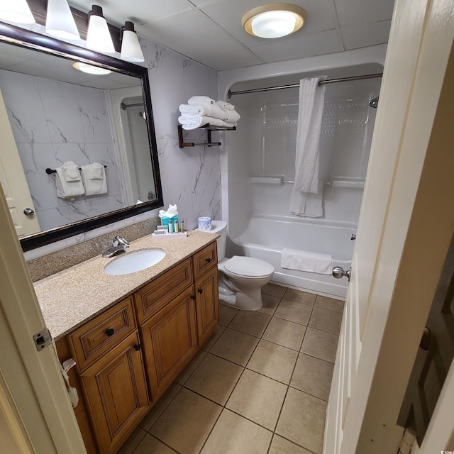 full bathroom with vanity, tile flooring, toilet, and tiled shower / bath