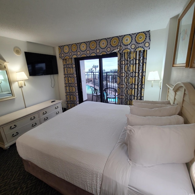 bedroom featuring dark colored carpet and access to outside