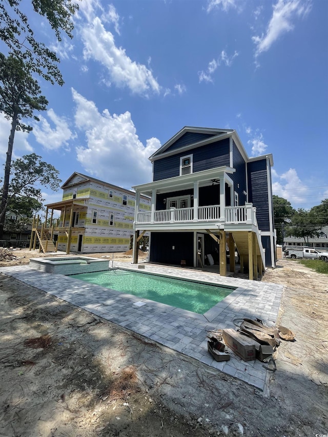 721 10th Ave S, Surfside Beach, SC 29575 - rear view of property with stairs, a patio area, a deck, and a pool with connected hot tub