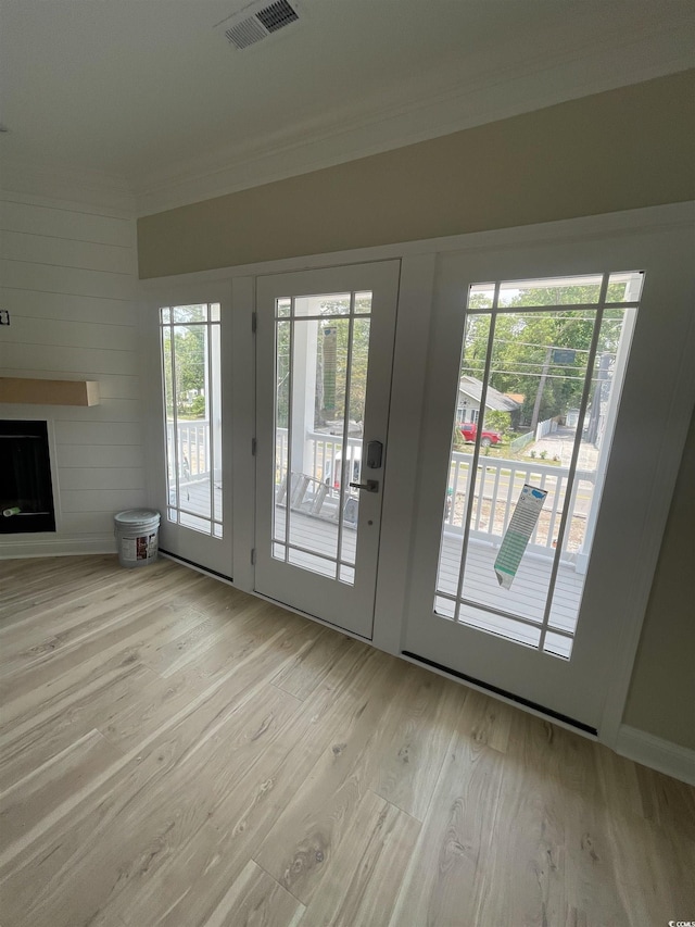 721 10th Ave S, Surfside Beach, SC 29575 - entryway featuring crown molding, light wood-style floors, and a fireplace